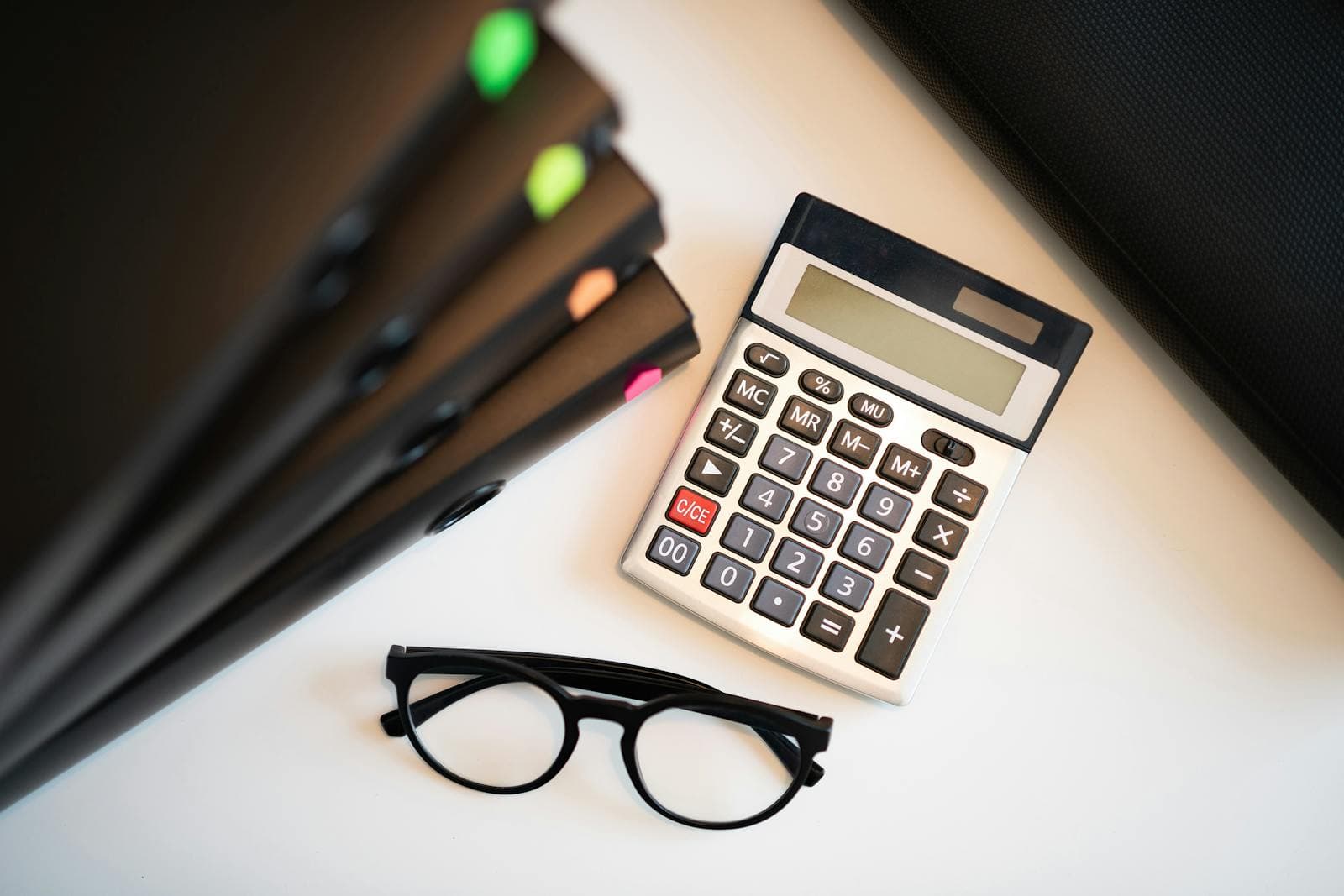 Financial reports and calculator on a business banking desk